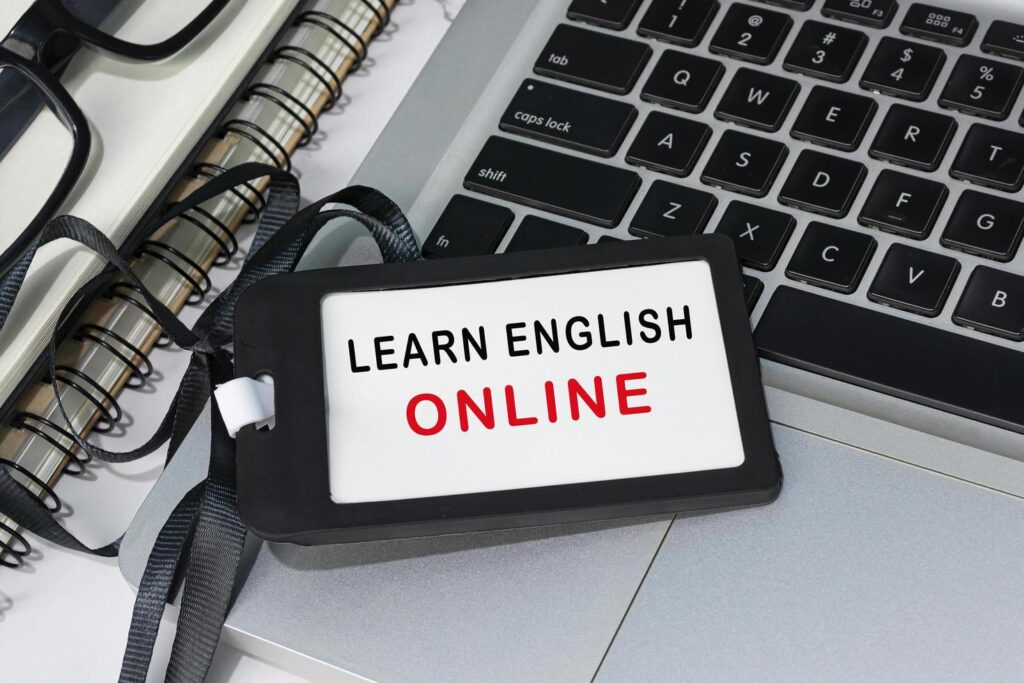 learn english online text written on black name tag placed on a laptop free photo
